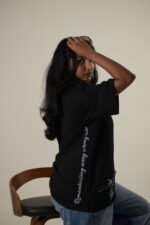 Black oversized tee with travel stamps and Romanticising every wrong turn sleeve print on women Lascialo Essere Every Wrong Turn Drop 01